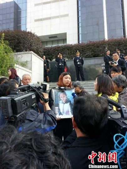 法院外，死者祁某的家人正在接受媒體采訪。 田雯 攝