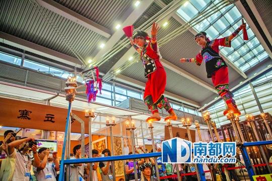 2號(hào)展館，苗族姑娘表演踩燈泡絕技《電光玫瑰》，赤腳踩上40瓦的燈泡并做出高難度動(dòng)作。 南都記者 霍健斌 攝