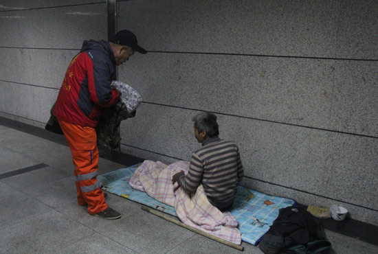 在鄭州一處地下通道，孫德坤挑了幾件衣服送給了流浪者