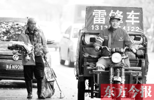 鄭州市商城路，一名環(huán)衛(wèi)工懷抱著剛剛收到的毯子，目送“雷鋒哥”孫德坤離開(kāi)